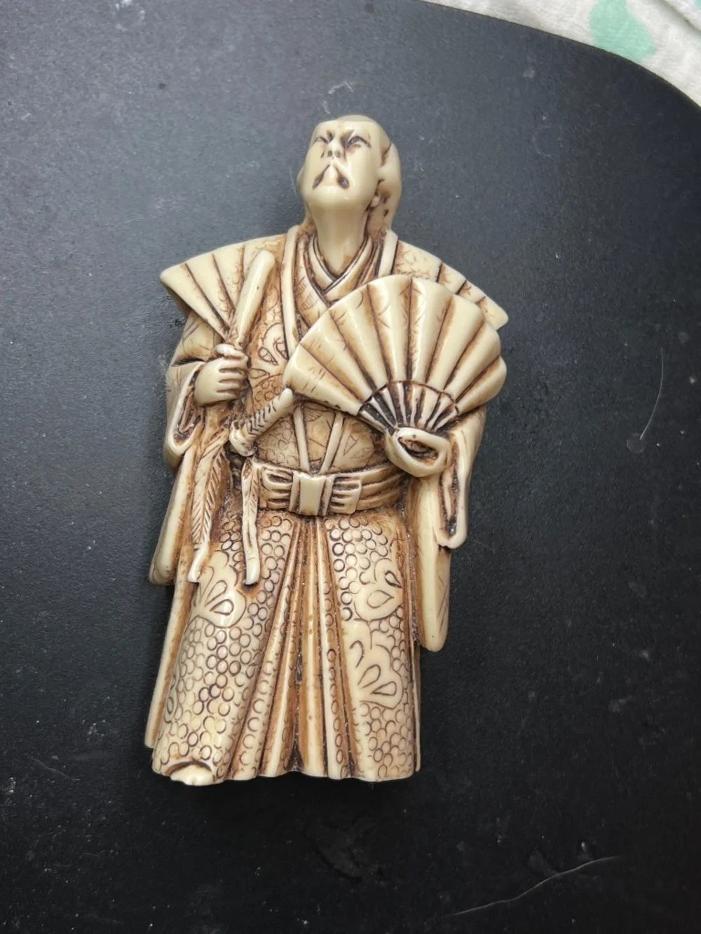 Hand-carved Japanese figurine likely a samurai or similar figure